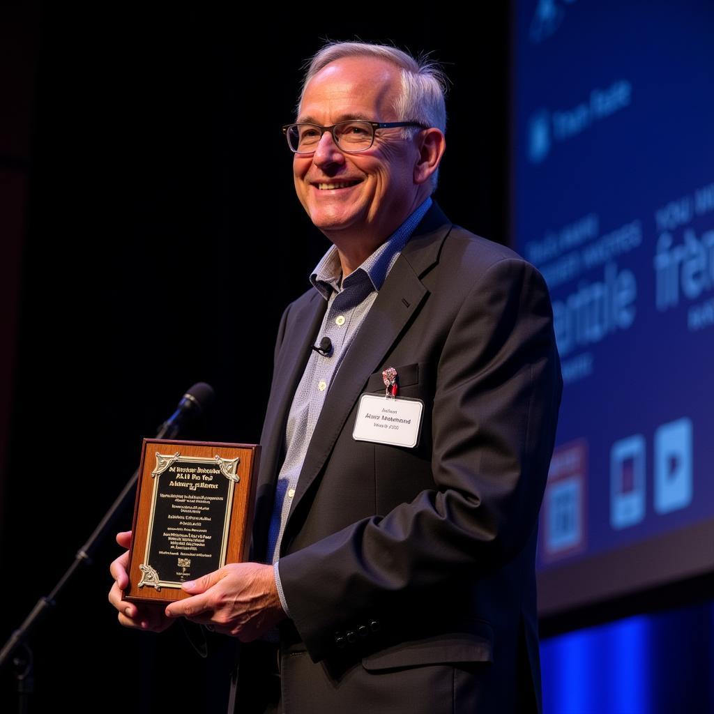 Alan Forrest accepting an award for his work