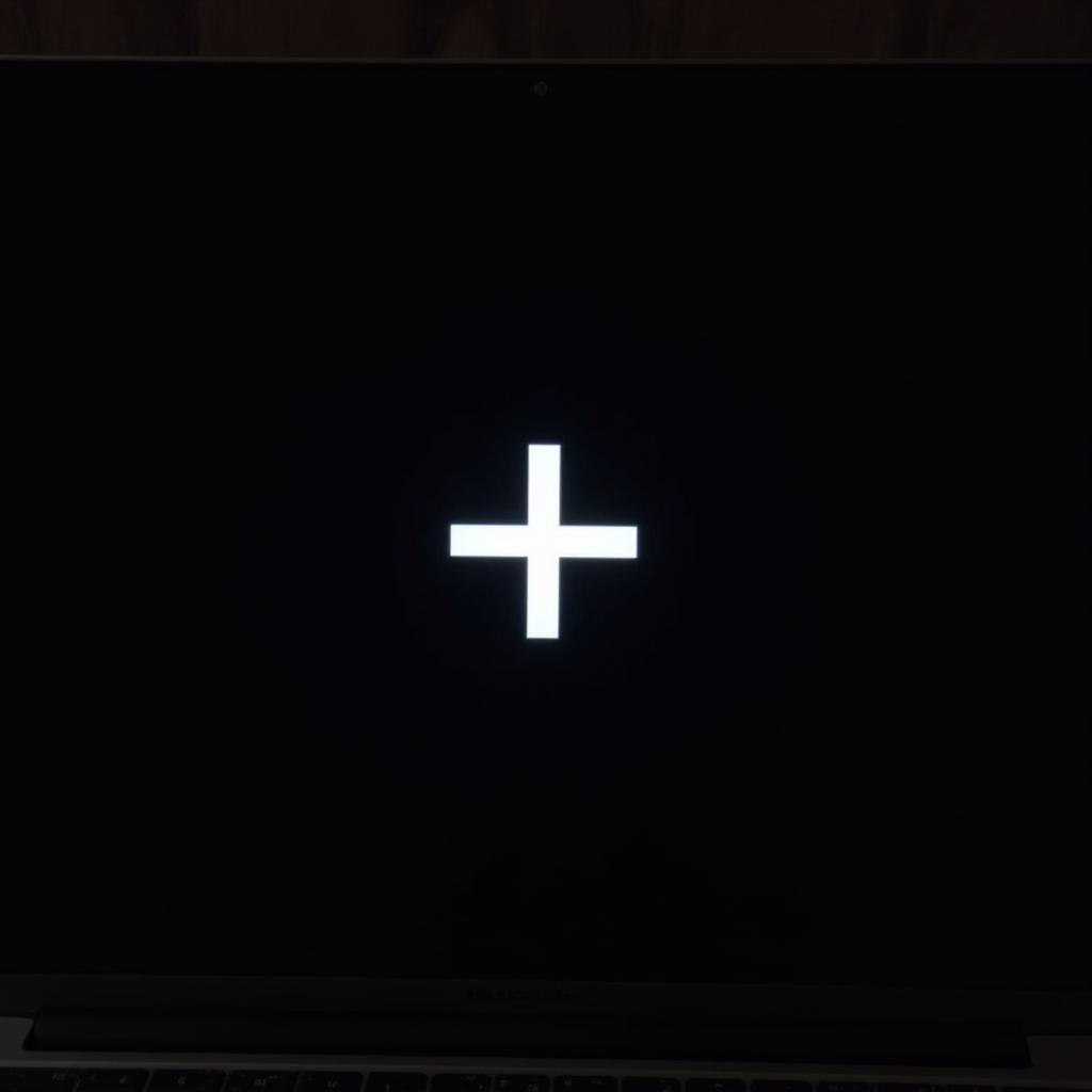 Laptop Displaying Black Screen with a Cross