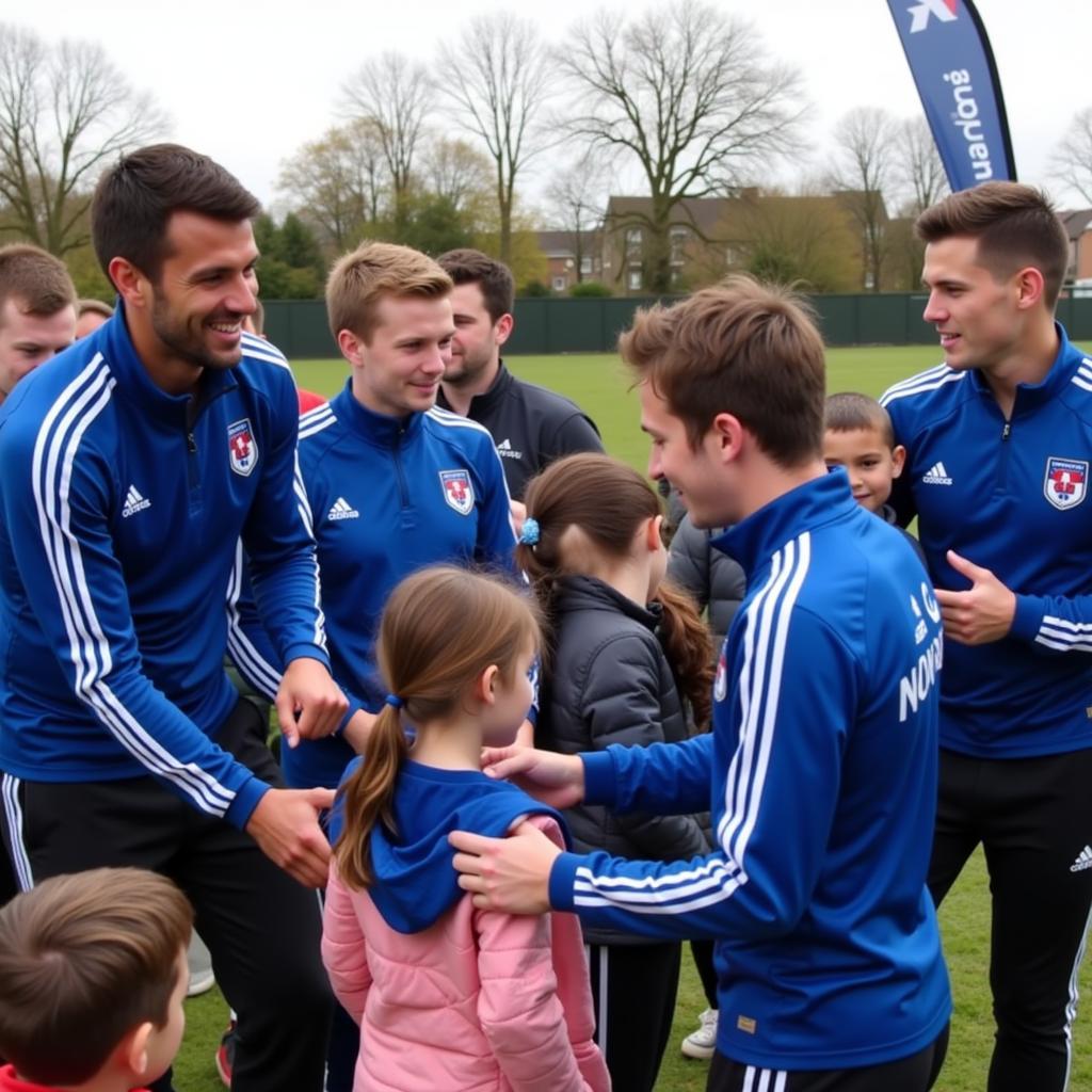 Blackburn Rovers players participating in a community event alongside sponsors