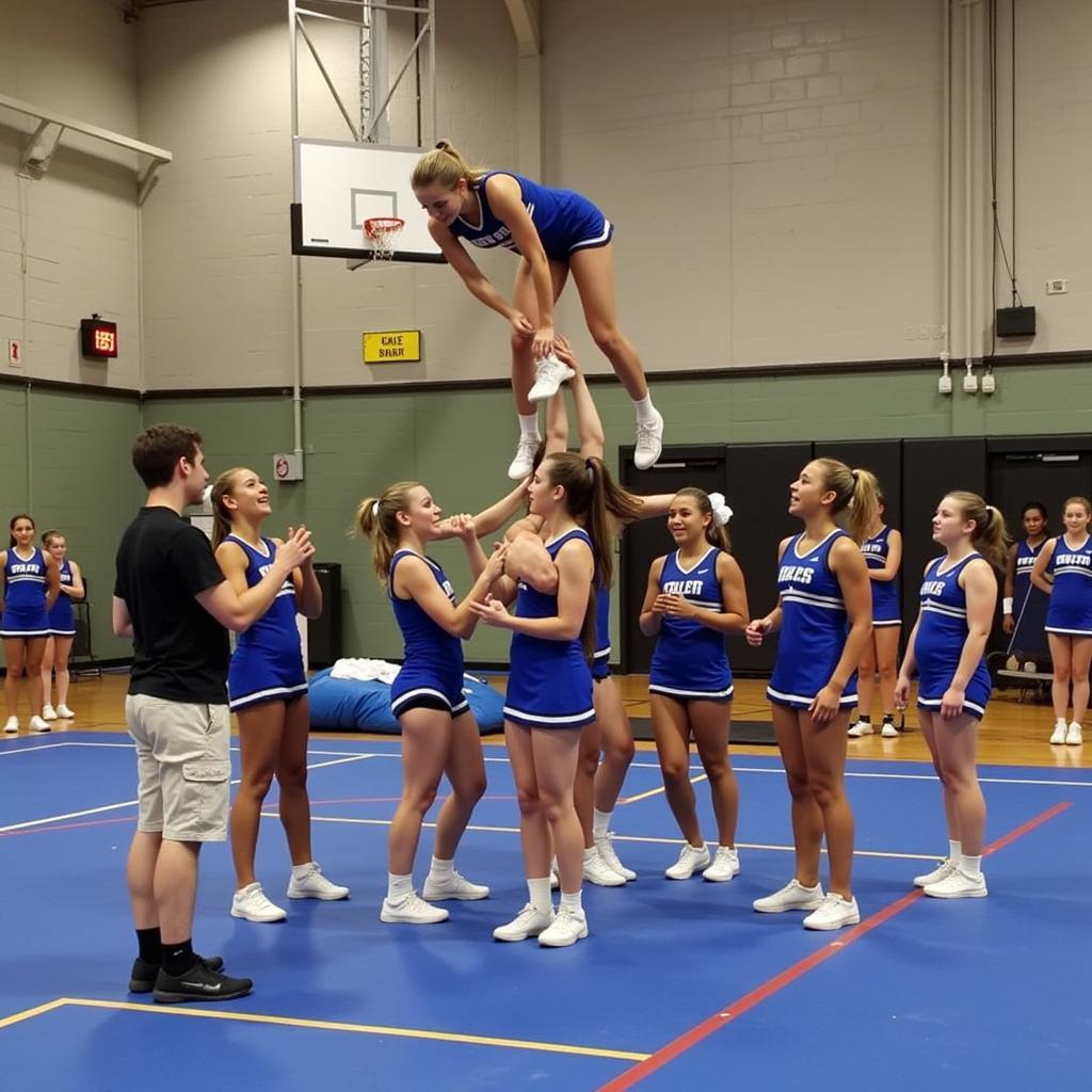 Cheerleaders Practicing Stunts with Spotters