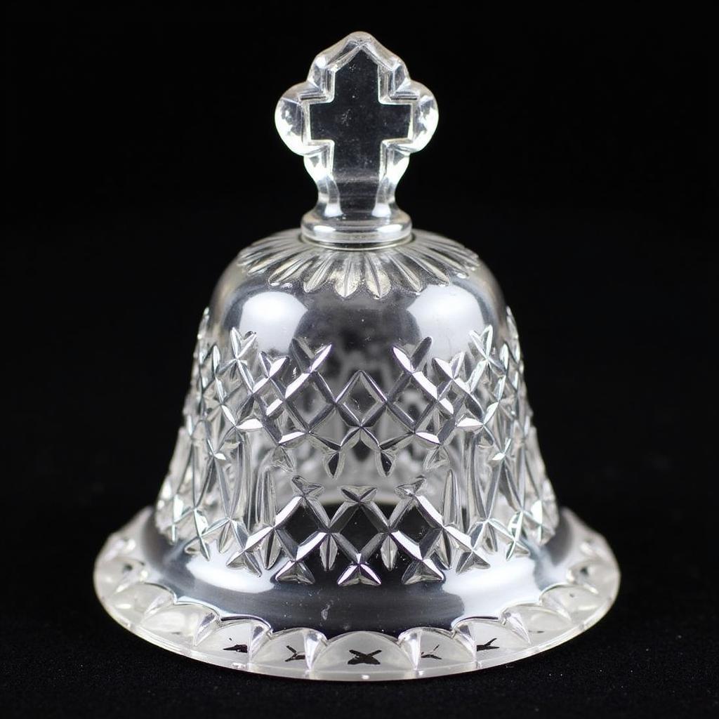 A close-up view of a vintage crystal bell, showcasing the intricate details and clarity of the crystal.