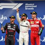 Formula One drivers celebrating on the podium