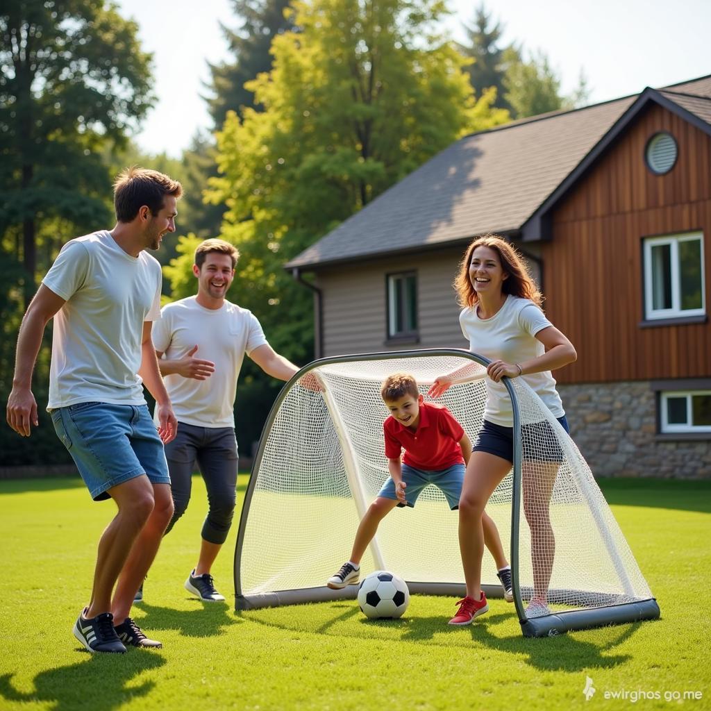 A family enjoying a game of football using portable goals in their backyard