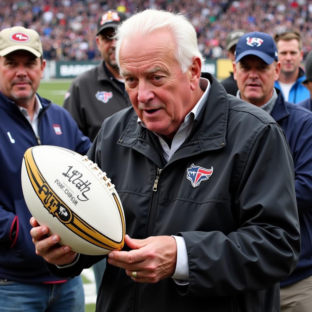 John Madden Signing a Football