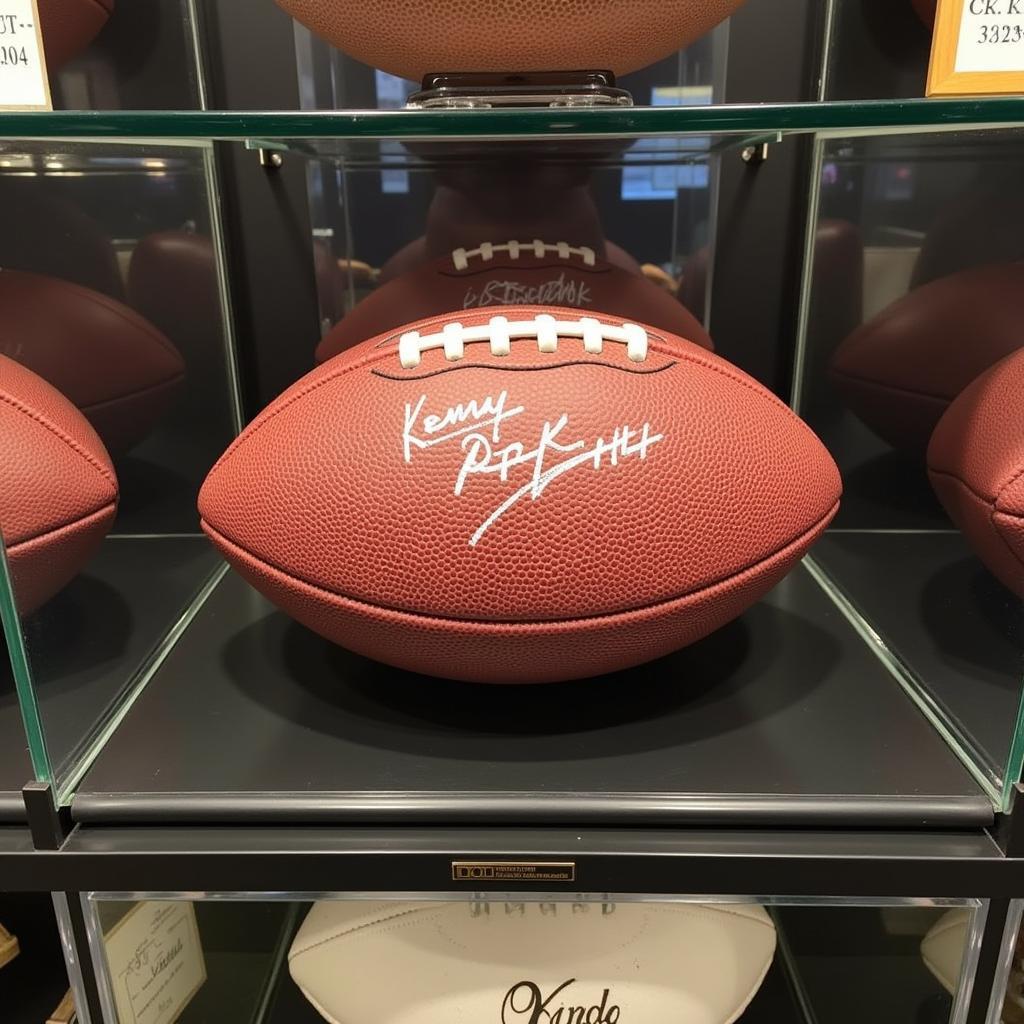 A display case containing a Kenny Pickett autographed football.