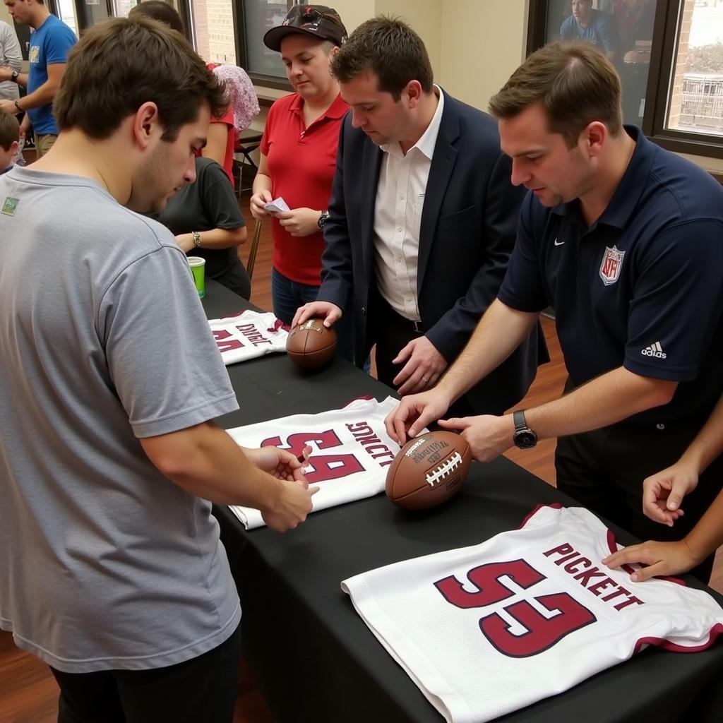 Kenny Pickett signing autographs for fans.