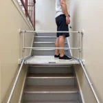 Ladder platform in use on a staircase