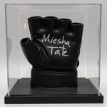 A Miesha Tate autographed glove displayed in a glass case