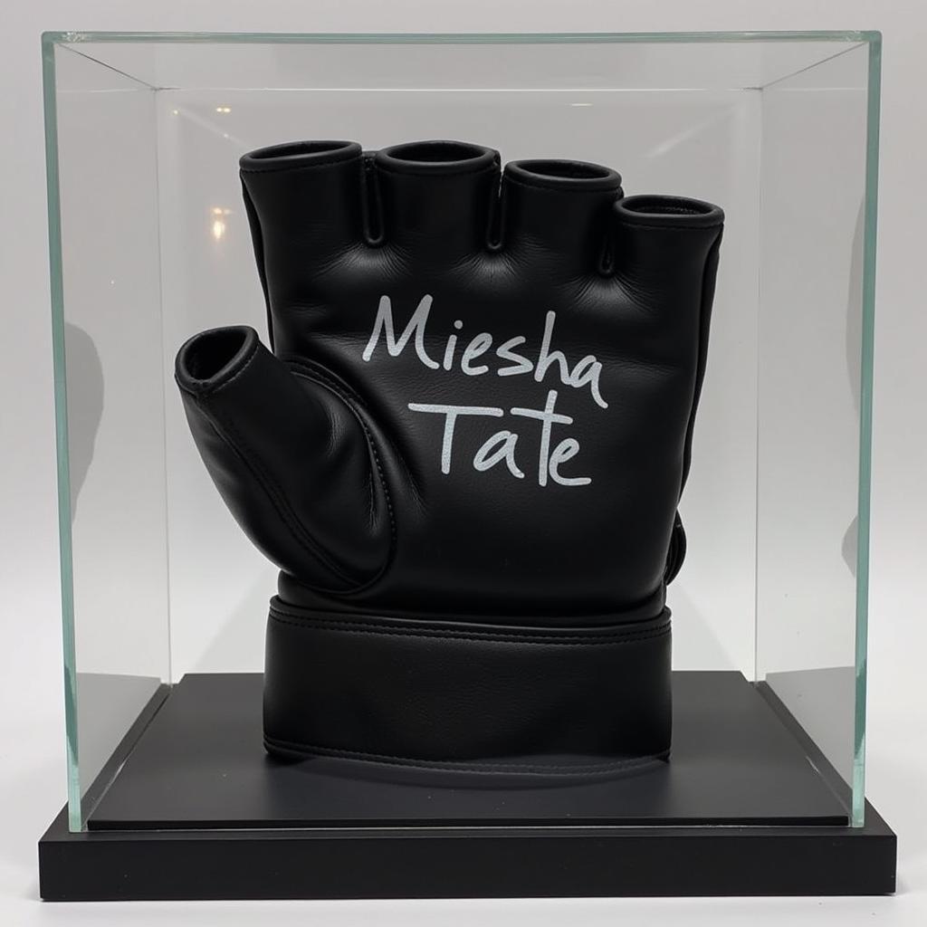 A Miesha Tate autographed glove displayed in a glass case