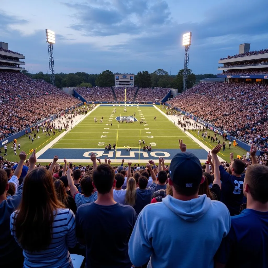 ODU football fans celebrating a touchdown in the stadium.