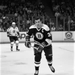 Cam Neely in Action: A dynamic image capturing Cam Neely during a game, showcasing his intense playing style and iconic presence on the ice.