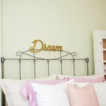 Metal Word Wall Art in a Bedroom Setting