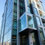 Modern Glass Outside Elevator on a High-Rise Building