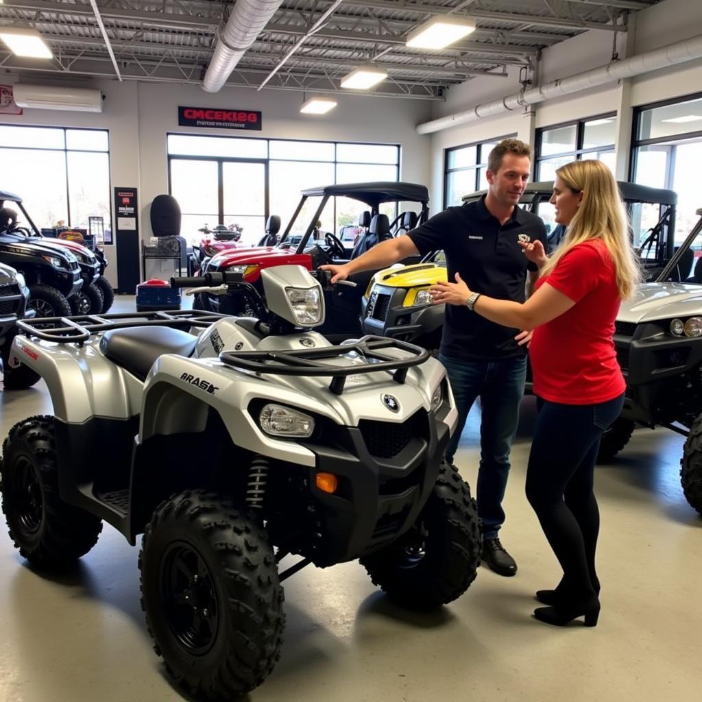 Knowledgeable staff assisting a customer in the Sterling Power Sports showroom